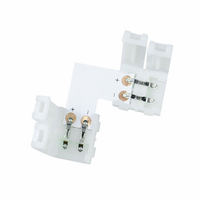 L-connector voor LED strip verlichting, wit kunststof, bovenaanzicht met zicht op de metalen contacten en aansluitpunten.