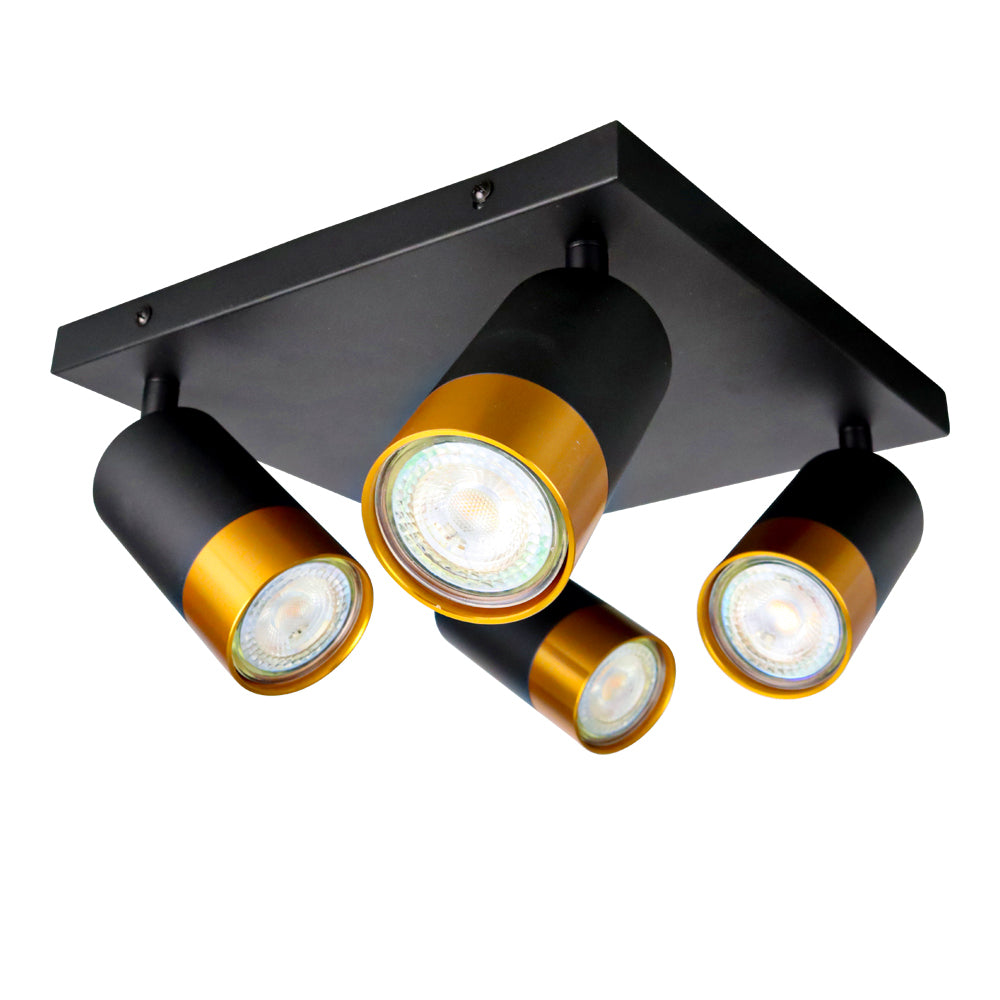 Moderne zwarte plafondspot met vier verstelbare cilindervormige lampen, afgewerkt met goudkleurige ringen, onderaanzicht.