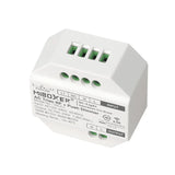 MiBoxer AC Triac RF Push Dimmer TRI-C1, bovenaanzicht schuin van voren met zicht op aansluitpoorten en productinformatie op de behuizing.